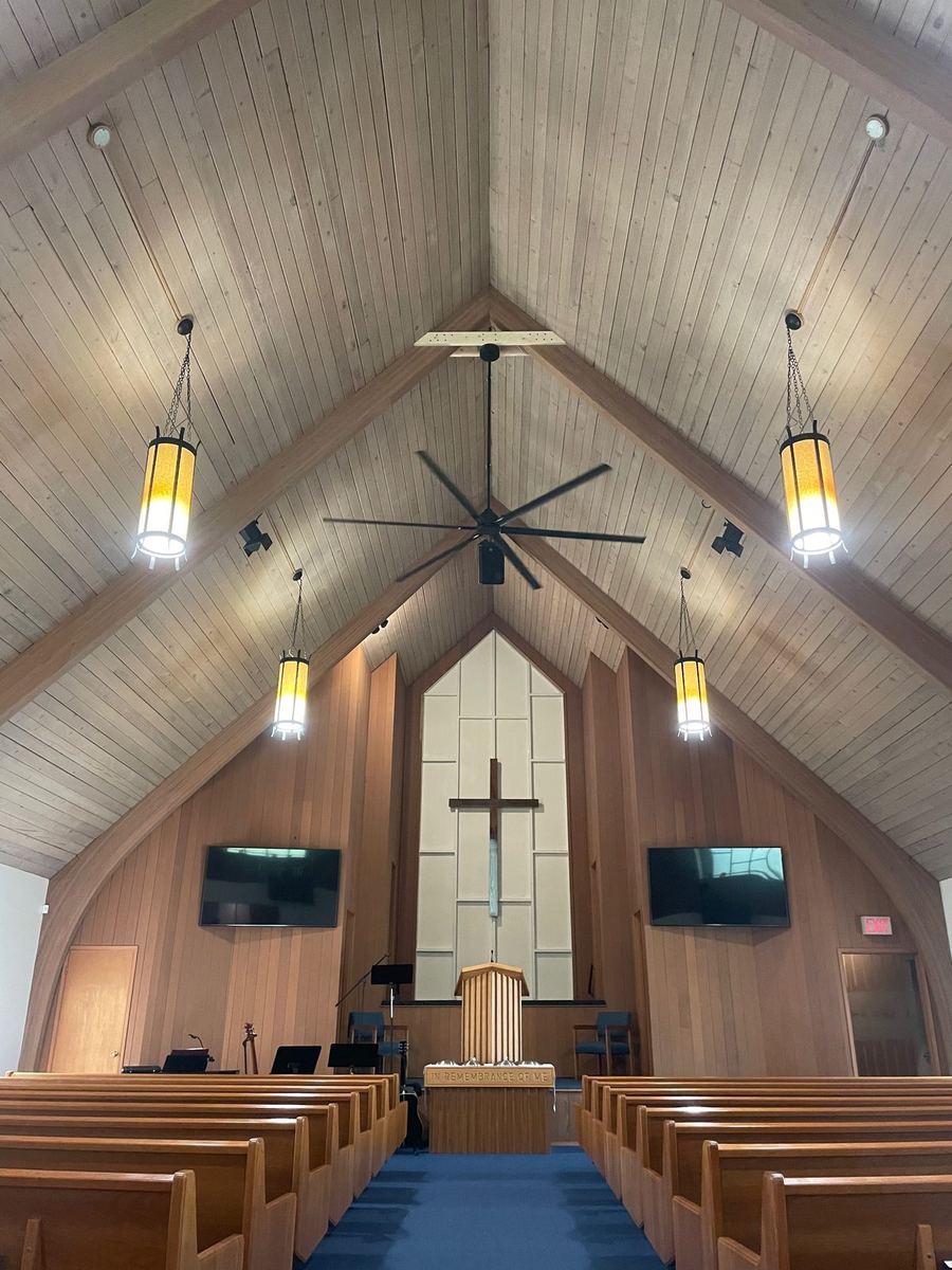 Church sanctuary interior with wood ceiling and pendant lights